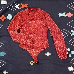 Lulus orange cheetah print body suit. Cheetah spots are a velvet material.